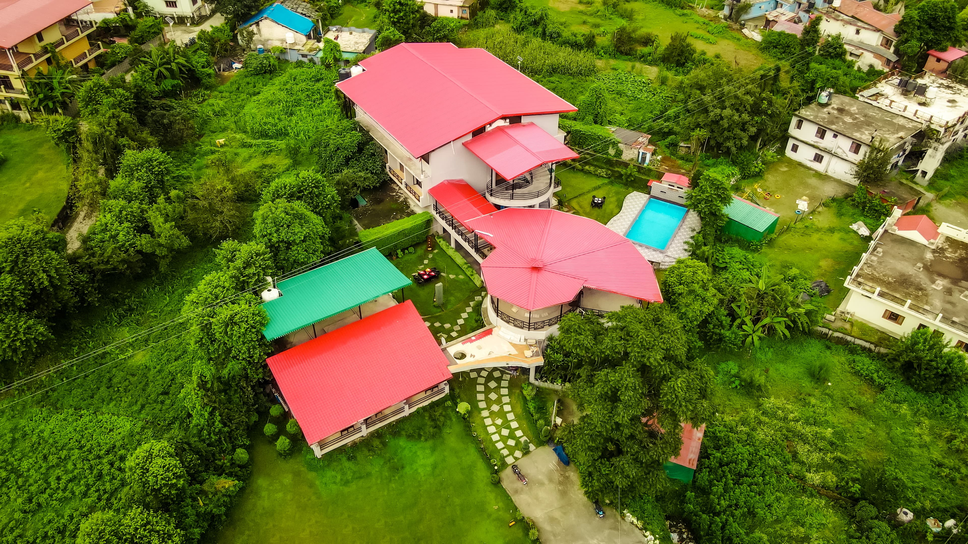 Aerial view of The Palm Resort by Vikalp in green Bhimtal surroundings