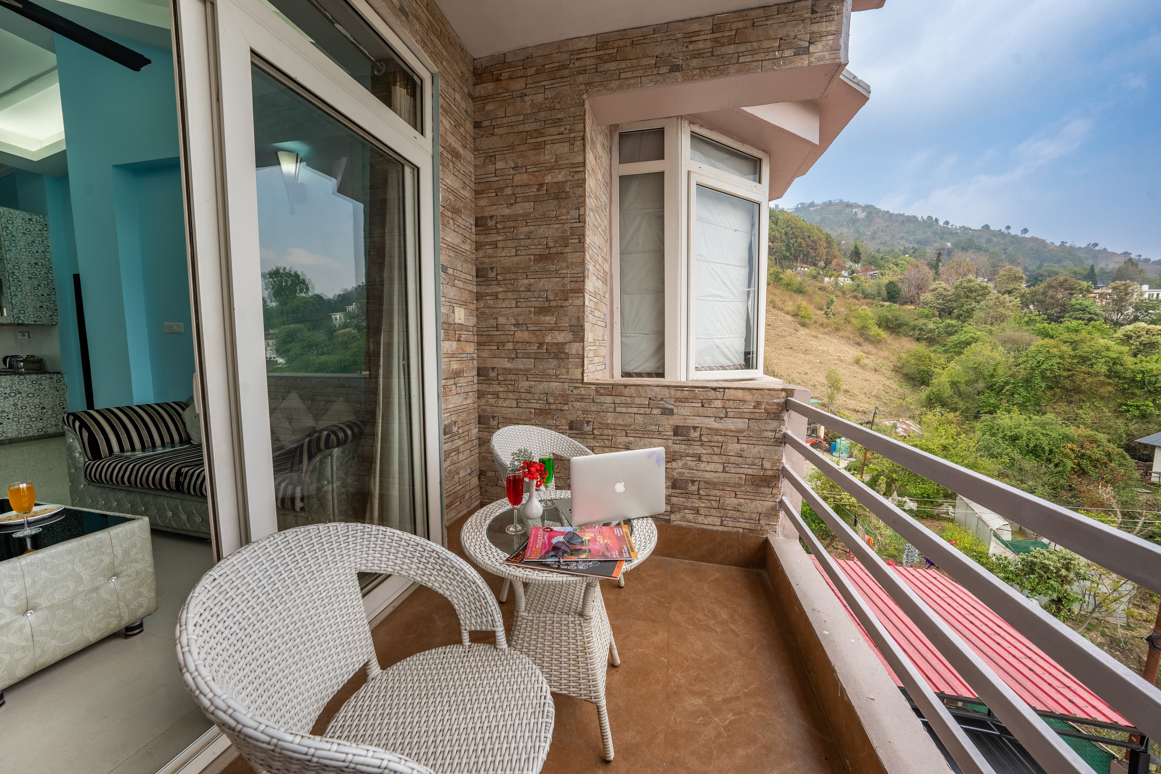 Private room balcony overlooking the green Kumaon hills