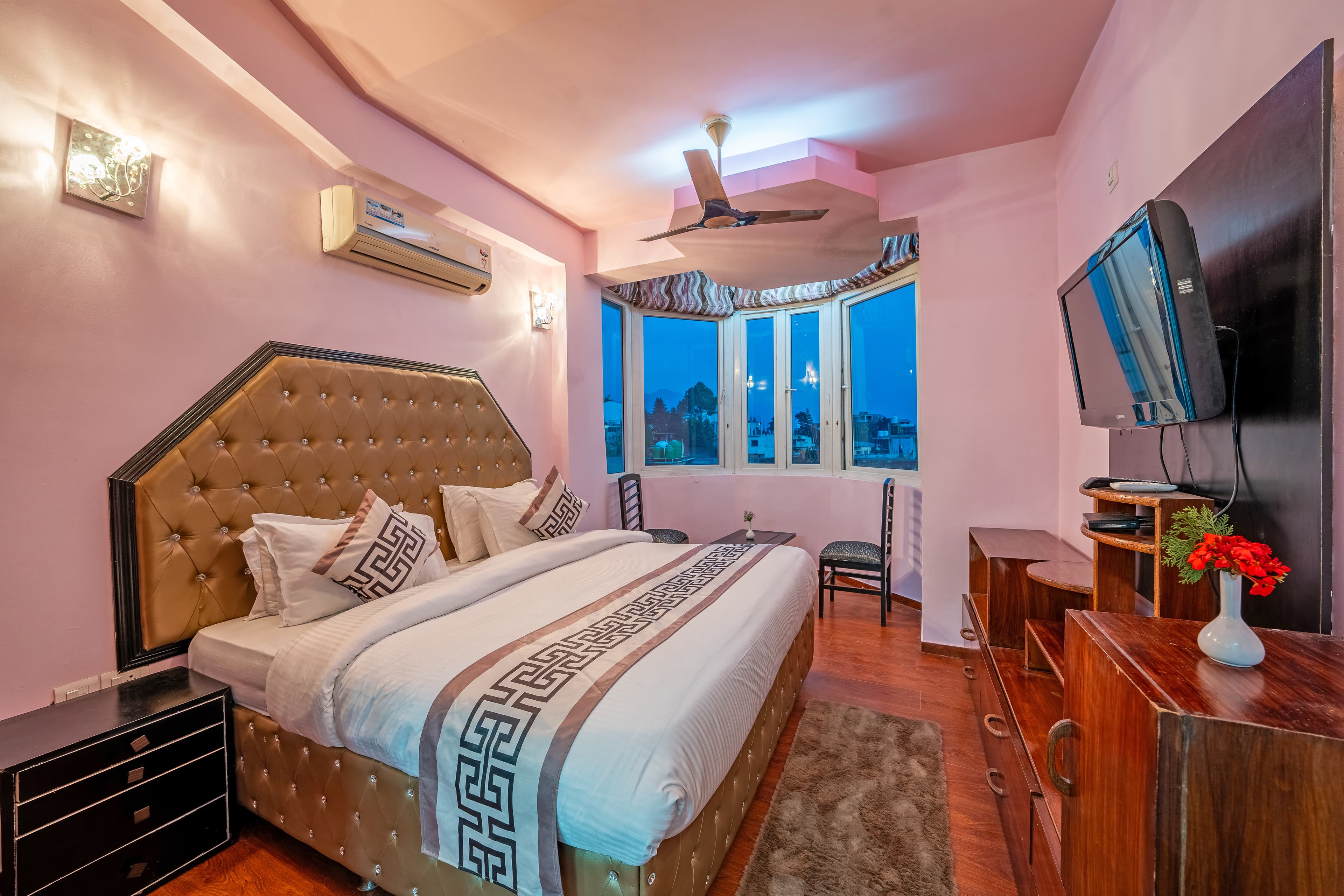 Premium Room with upholstered bed and bay window at The Royal Court